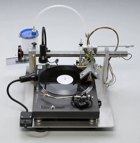 Close-up of a cutting head engraving fine grooves into a record